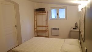 a small bedroom with a bed and a window at Gîte Valentine in Aubin