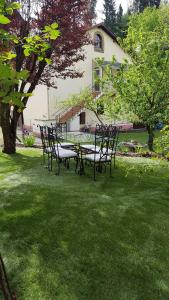 a group of chairs and a table in the grass at Gîte Valentine in Aubin
