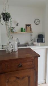 a kitchen with a wooden table and a microwave at Gîte Valentine in Aubin +12 photos