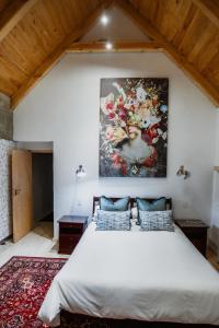 a bedroom with a large painting on the wall at Berghuis - Mountain Hideaway in Wolseley +32 photos