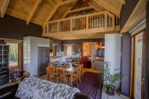 a kitchen and dining room with a wooden ceiling at Berghuis - Mountain Hideaway in Wolseley