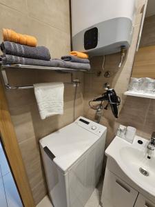 a small bathroom with a toilet and a sink at Split/Podstrana Apartment ADRIA in Podstrana
