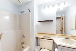 a bathroom with a sink and a toilet and a mirror at A Warren Beauty in Warren +25 photos