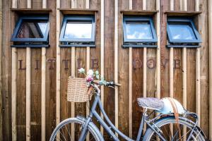 a bike parked in front of a wooden wall at Little Dove, Orford in Woodbridge