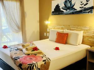 Un dormitorio con una cama con flores. en Pousada CasAlice, en Jericoacoara