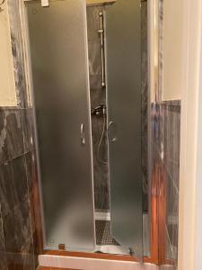 a shower with a glass door in a bathroom at L'orologio matto in Marina di Carrara