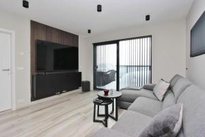 a living room with a couch and a flat screen tv at Beautiful apartment in Akureyri in Akureyri