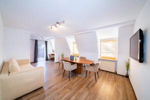 a living room with a table and a couch at ArtHotel City in Nuremberg