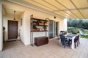 a patio with a table and some chairs and a table and a tableablish at Casavacanzelemore - Casa Zoe in Valfabbrica
