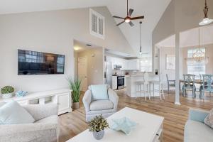 a living room with a couch and a table at Cottages of Crystal Beach Sea La Vie in Destin