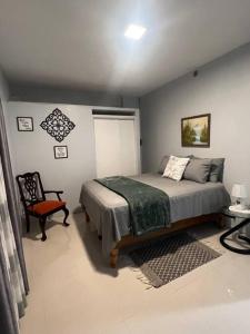 a bedroom with a bed and a chair at Sunrise Manor 2-Bedroom APT#2 in Cherryfield