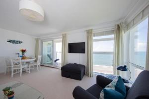 a living room with a view of the ocean at High-End Beachfront Getaway Sea View King Bed in East Wittering