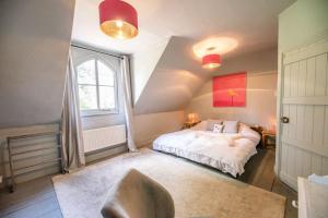 a bedroom with a white bed and a window at Dove Point, Orford in Woodbridge