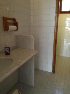 a bathroom with a sink and a toilet paper dispenser at Hotel Efes in Gumuldur