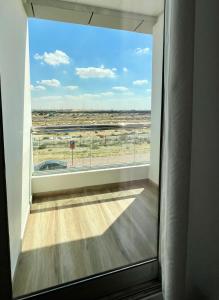 a room with a large window with a view of the desert at Silicon Path Spacious studio in Dubai