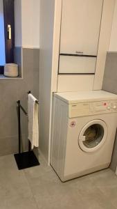 een wasmachine en droger in de badkamer met bij Ferienhaus Allgäu Flughafen Memmingen in Benningen
