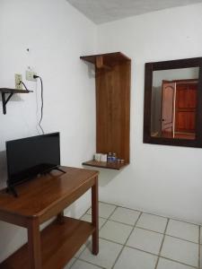 a room with a desk with a television and a mirror at Hotel Paraíso de San Sebastián Jalisco in San Sebastián del Oeste