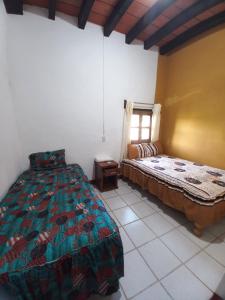 a bedroom with a bed and a window at Hotel Paraíso de San Sebastián Jalisco in San Sebastián del Oeste