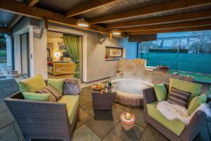 a patio with chairs and a tub in a room at Vilka u Dyje in Znojmo +13 photos