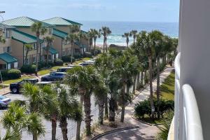 widok na ulicę z palmami i ocean w obiekcie Villas at Destin West Gulfside V403 w mieście Fort Walton Beach