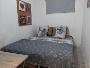 a bed with two pillows on it in a room at Beach Apartment in Tel Aviv
