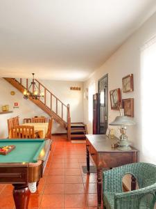 a living room with a pool table and a staircase at WelcomeBuddy - Casa da Praia - Moinhos Beach in Porto Formoso