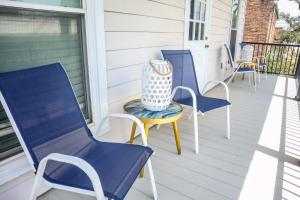 a group of blue chairs on a porch at Cozy 2BR Apartment, Balcony with City Skyline View, Mardi Gras Park, Free Parking, Wi-Fi in Mobile