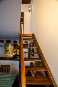 a stairway in a kitchen with wooden shelves at WelcomeBuddy - Casa da Praia - Moinhos Beach in Porto Formoso