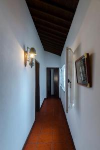 a hallway with white walls and a wooden ceiling at WelcomeBuddy - Casa da Praia - Moinhos Beach in Porto Formoso