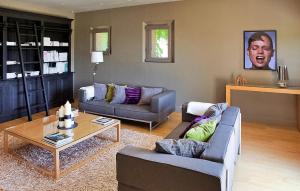 a living room with two couches and a coffee table at Le Mas De La Vigne in Violès +31 photos