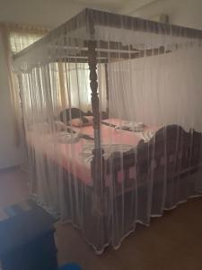 a bed with a canopy in a room at Damith Guest House in Unawatuna