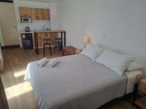 een slaapkamer met een bed met twee handdoeken erop bij Venue Studios in Lima