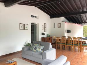a living room with a couch and a table at Casa do Monte – Sea sight in Lagoa