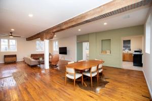 a dining room and living room with a table and chairs at Farmville Modern Loft in Farmville