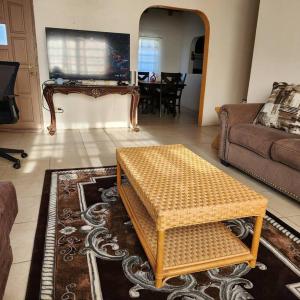 a living room with a couch and a table at Fruit Tree Castle in Kingshill