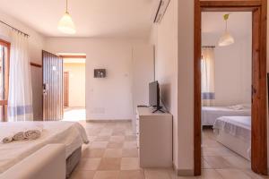 a bedroom with two beds and a flat screen tv at Baia Turchese Olbia in Olbia +220 photos