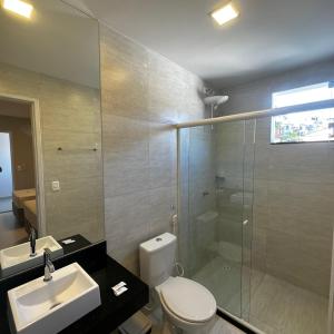 a bathroom with a toilet and a sink and a shower at ONIX AGUAS CLARAS in Salvador