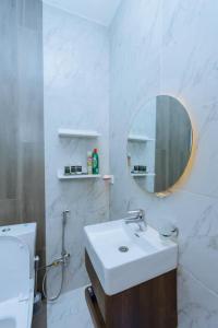 a bathroom with a sink and a mirror and a toilet at Nice Homes Villa in Kigali