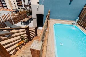 a swimming pool next to a building at Pousada Capital das Águas in Maceió