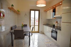 a kitchen with a table and a dining room at La Casa dell'Artista in Trieste