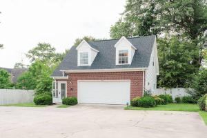 a red brick house with a white garage at Kinston Hideaway in Kinston