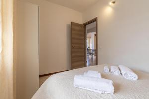 a bedroom with a bed with towels on it at Baia Turchese Olbia in Olbia