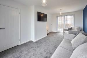 a living room with a couch and two chairs at Host & Stay - Marsden Beach House in South Shields