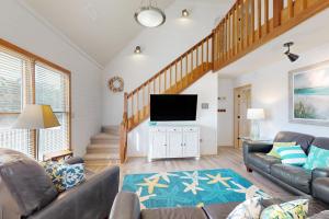 a living room with a couch and a flat screen tv at AVHC41 Outrigger Cottage on Hatteras Island in Avon