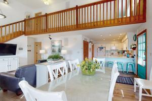 a kitchen and living room with a table and chairs at AVHC41 Outrigger Cottage on Hatteras Island in Avon
