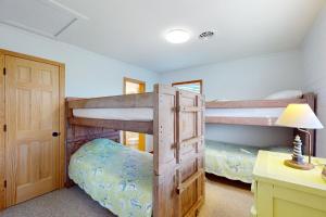 two bunk beds in a room with a desk at AVHC41 Outrigger Cottage on Hatteras Island in Avon +31 photos