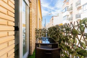 a wicker chair sitting next to a building at Enjoy Valencia: Deluxe Apartment with Terrace in Valencia