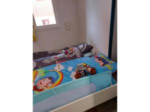 a childs bedroom with a bunk bed with toys on it at Appartement 6 personnes in Saint-François-Longchamp