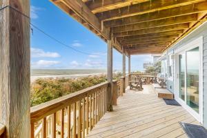 a wooden porch with a view of the beach at Sea Star #44-B in Buxton