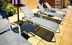 a group of chairs sitting on a patio at Le Mas De La Vigne in Violès